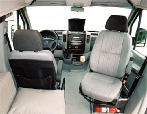 Interior view of cockpit in a Mercedes Sprinter van.